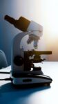 a light microscope placed on a white surface